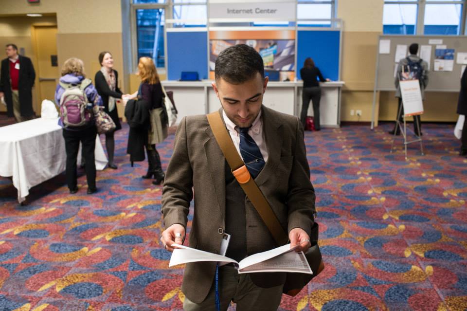 A historian walks through the 2015 annual meeting Internet Center looking at his program. Photo by Mark Monaghan.