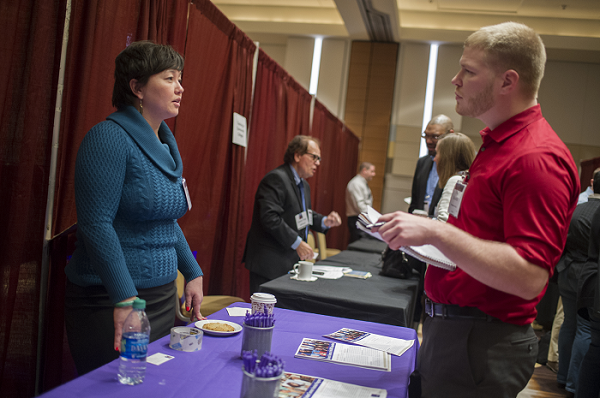 Stephanie Young from RAND Corporation conducts an informational interview with a Career Fair attendee. Marc Monaghan  